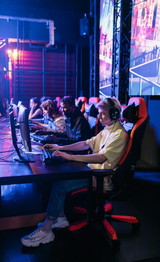 A team of gamers immersed in an e-sports competition, showcasing teamwork and focus.